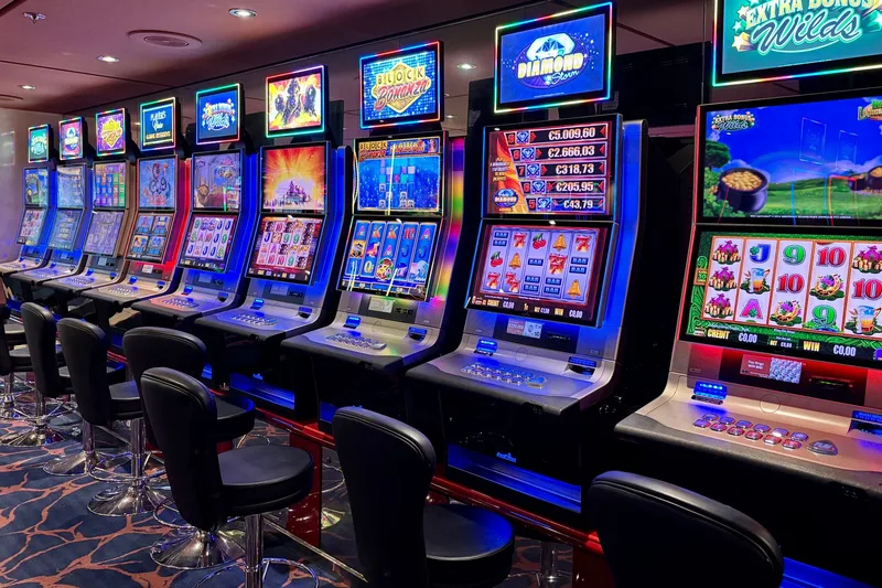 Bright casino slot machines with colorful displays and no people present. (stock photo via Pexels)