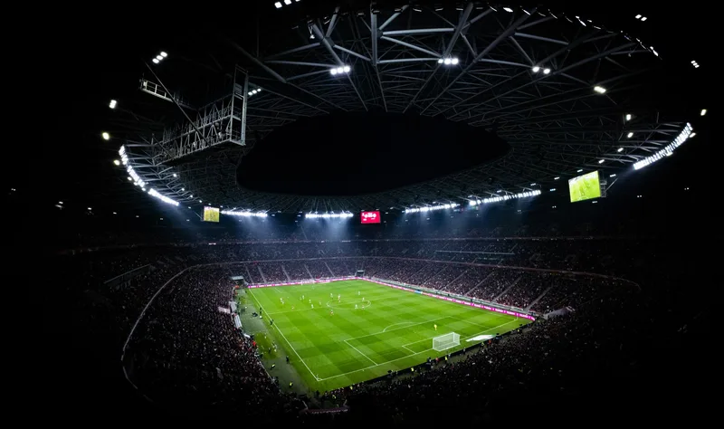 Aerial view of a night football match in Budapest. Illuminated stadium full of fans adds dramatic atmosphere. (stock photo via Pexels)